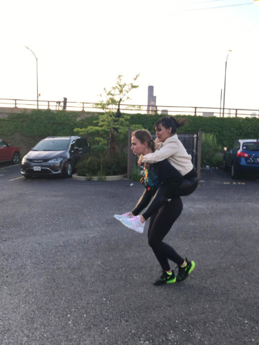 A woman carrying her friend on her back
