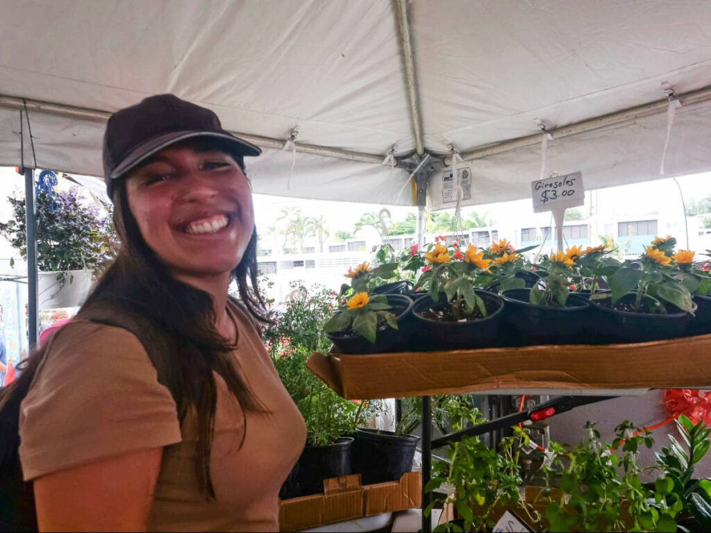 The author Vanessa Ramos smiling for a photo at the Airbonito’s Flower Festival