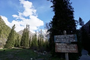 A sign showing split in trails at start of Ala Archa hike