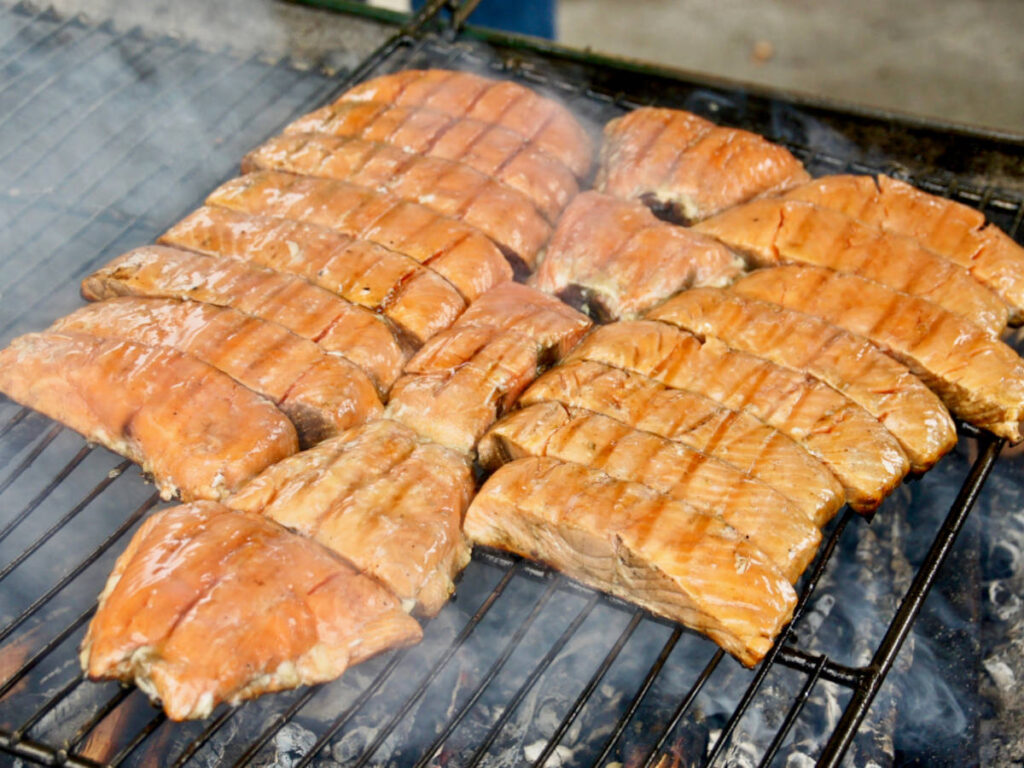 An Alaskan Salmon Bake being cooked on a griller