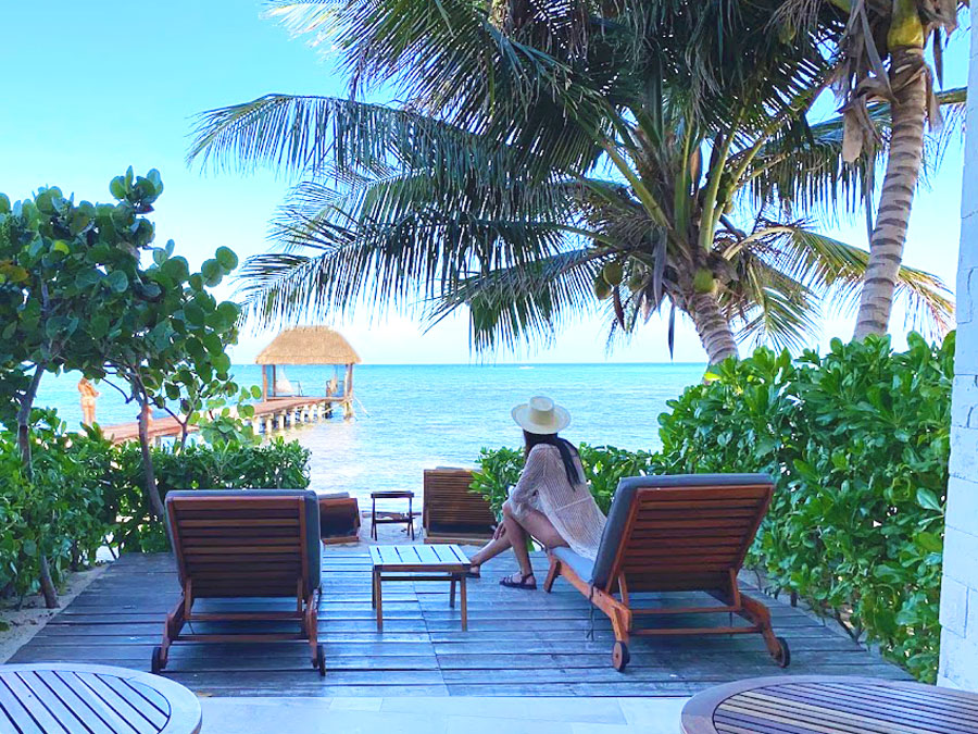 Clara sitting on a beach chair with the view of the beach