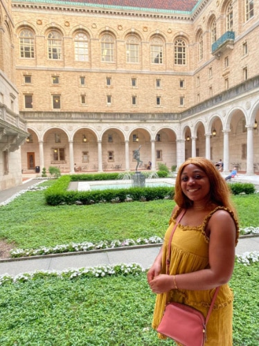 Alexandria Taylor smiling for a photo in Boston Public Library Garden