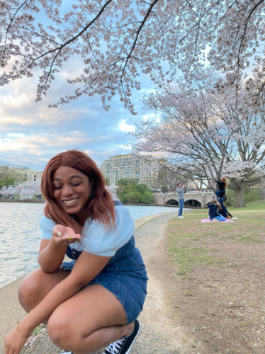The author Alexandria Taylor holding cherry blossom petals