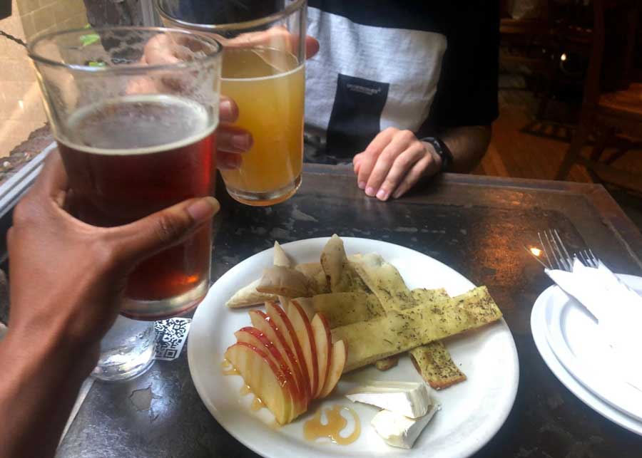 The author with her husband doing a cheers with their beer from Alibi Room