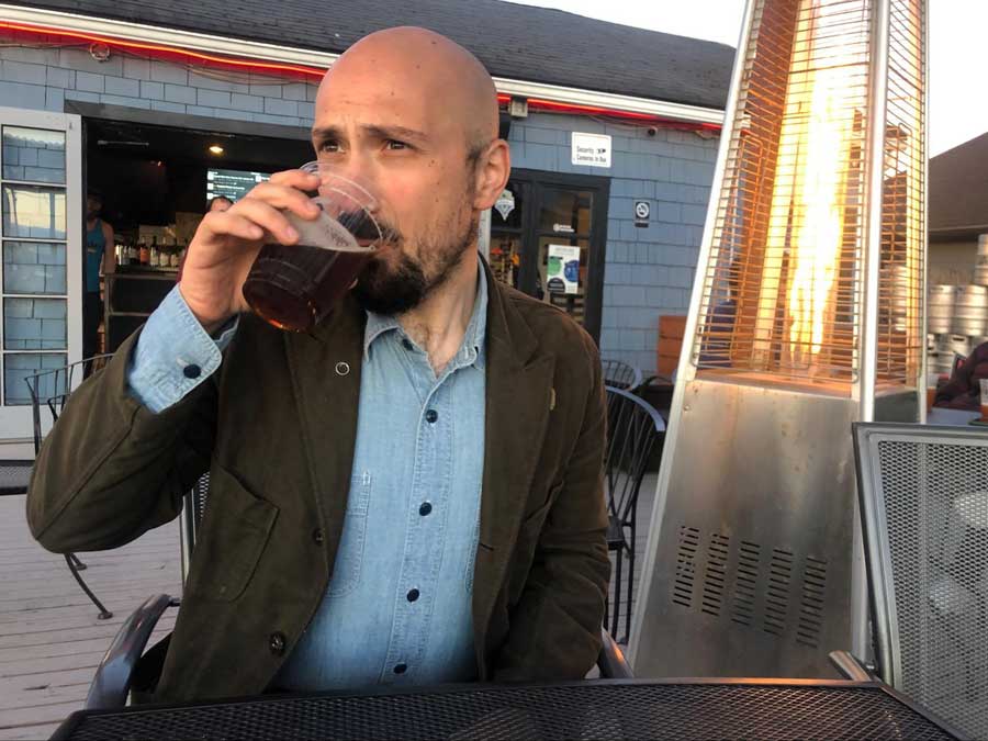 The author's husband enjoying his brew on the patio