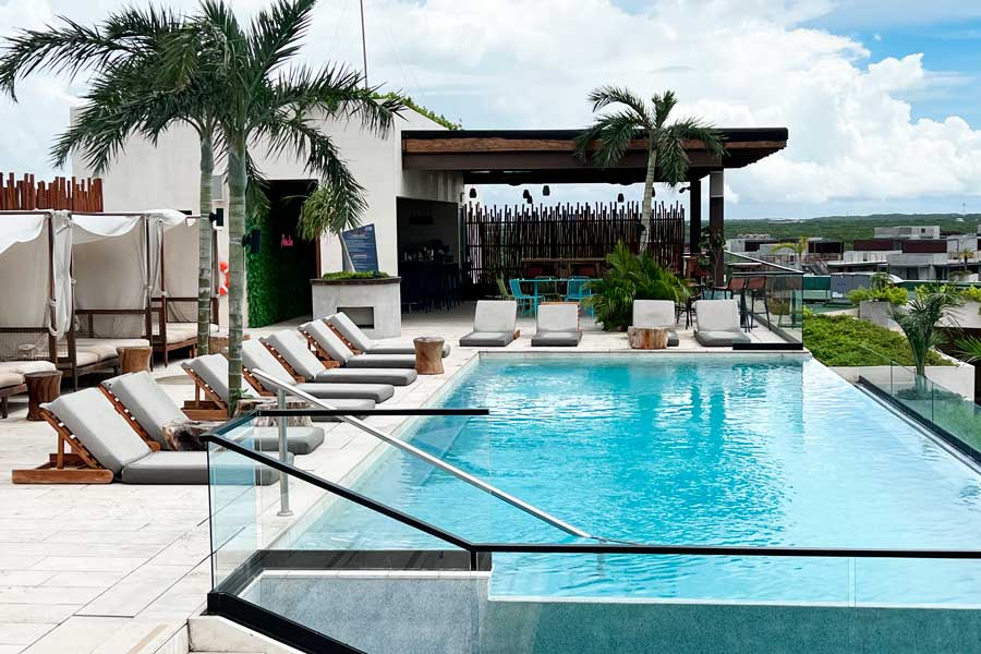 View of pool chairs in the pool area of Aloft Tulum