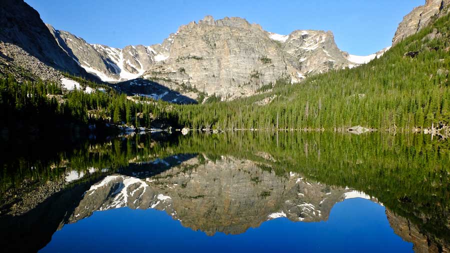 A reflection of a mountain on the Alpine Lake in Rocky Mountain National Park