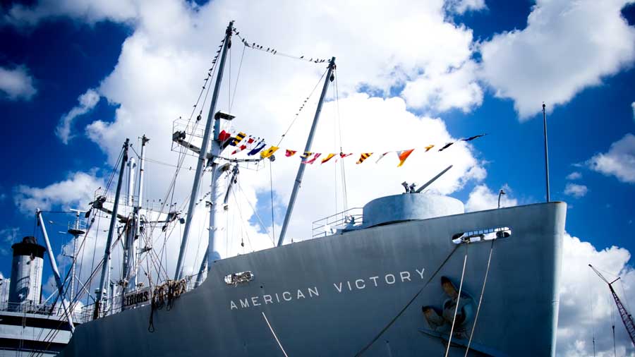 The American Victory ship with colorful buntings hanging above
