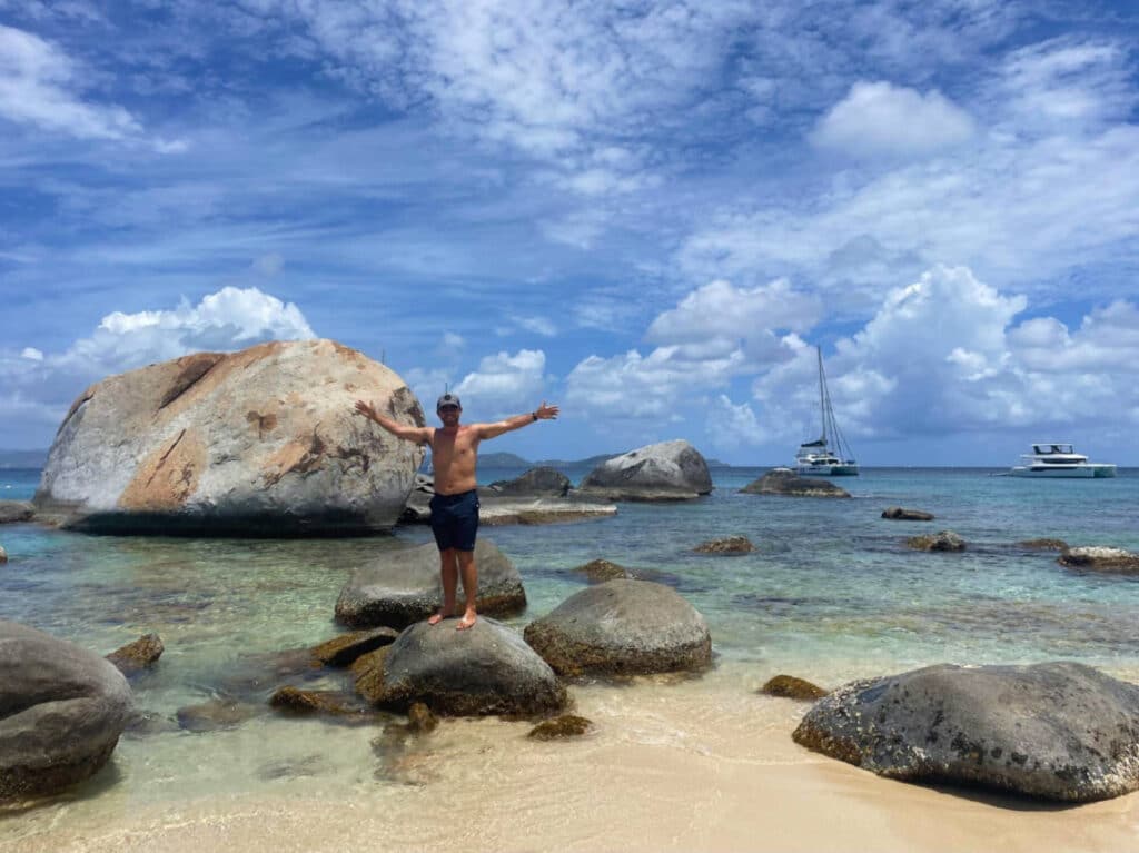 The author, Andrew Bloem posing for a photo on top of a rock at The Baths