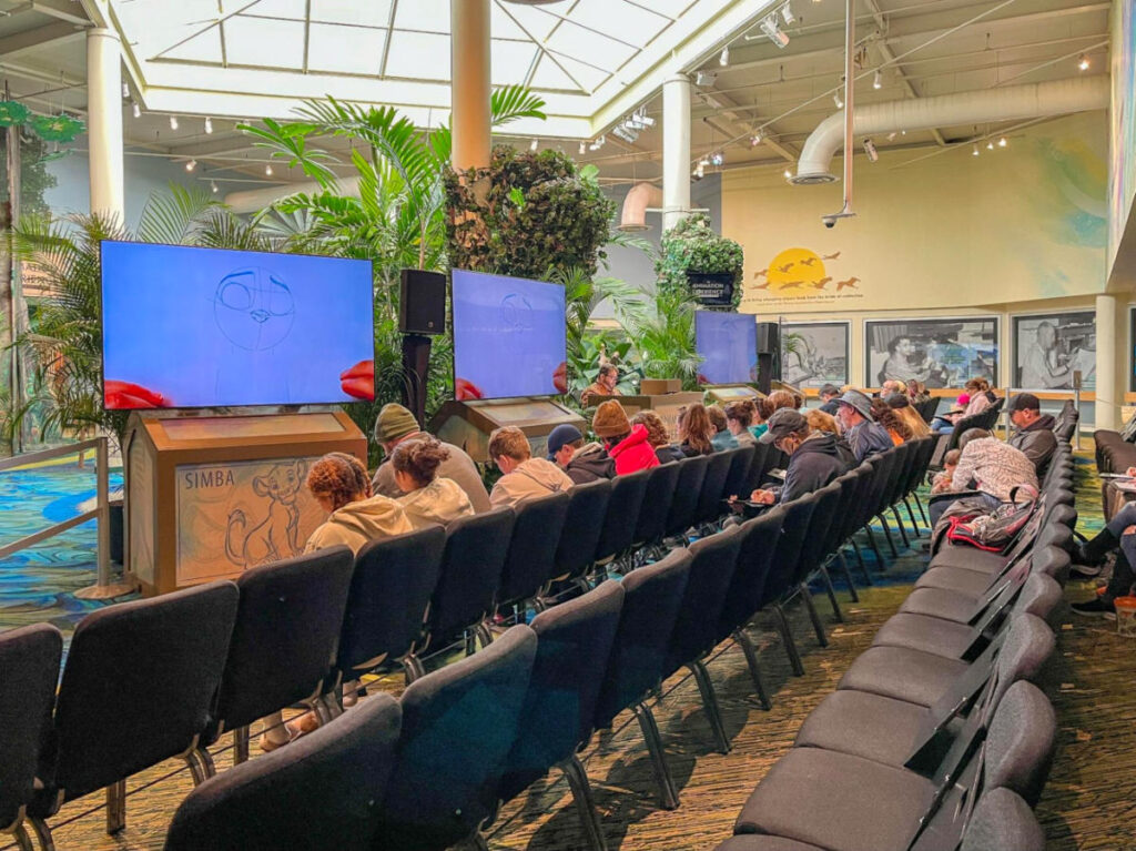 A group of people drawing Judy Hopps from Zootopia inside the Animation Experience, Conservation Station