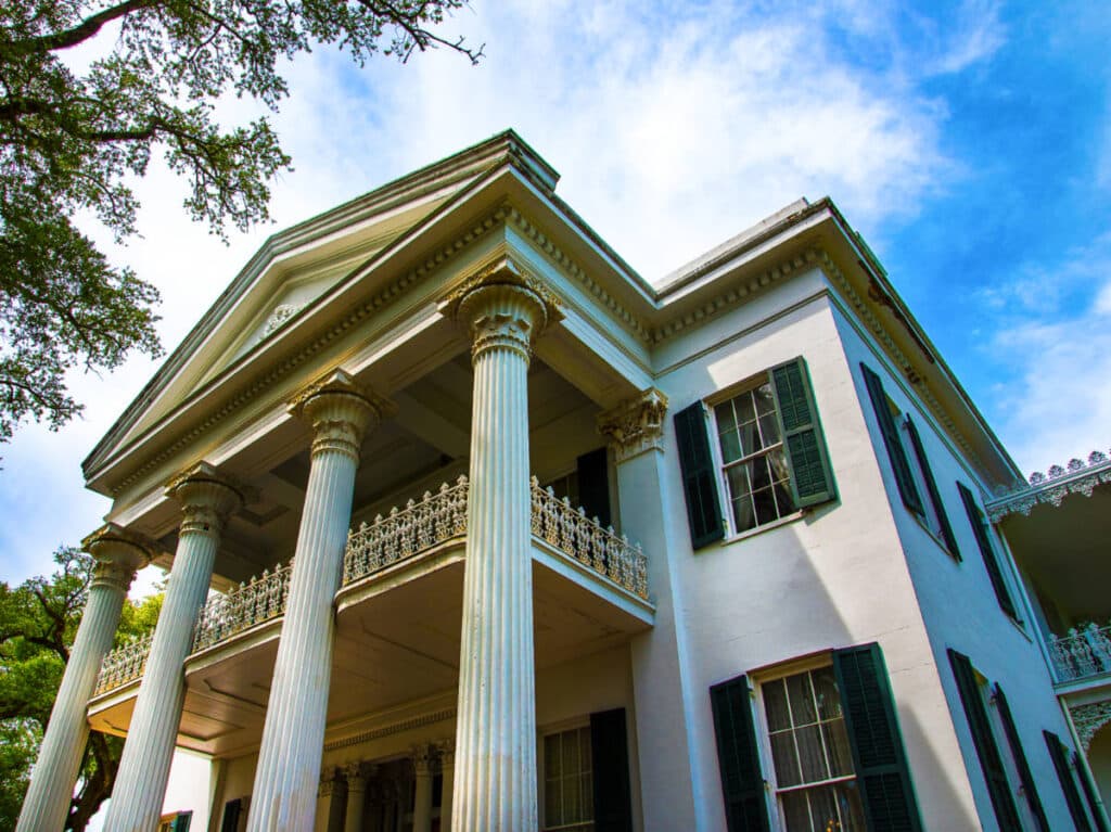 Low angle perspective of the white exterior of Antebellum House