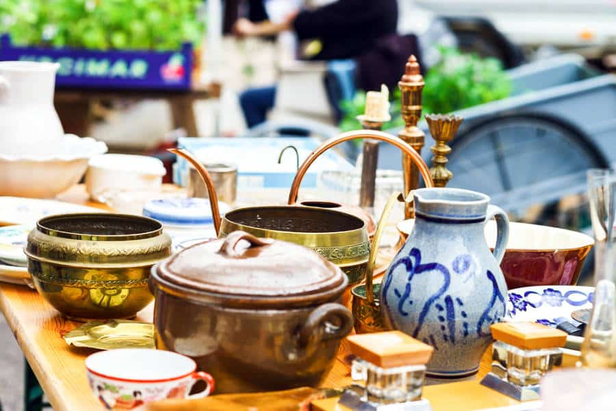 A table full of antique pots and ceramics