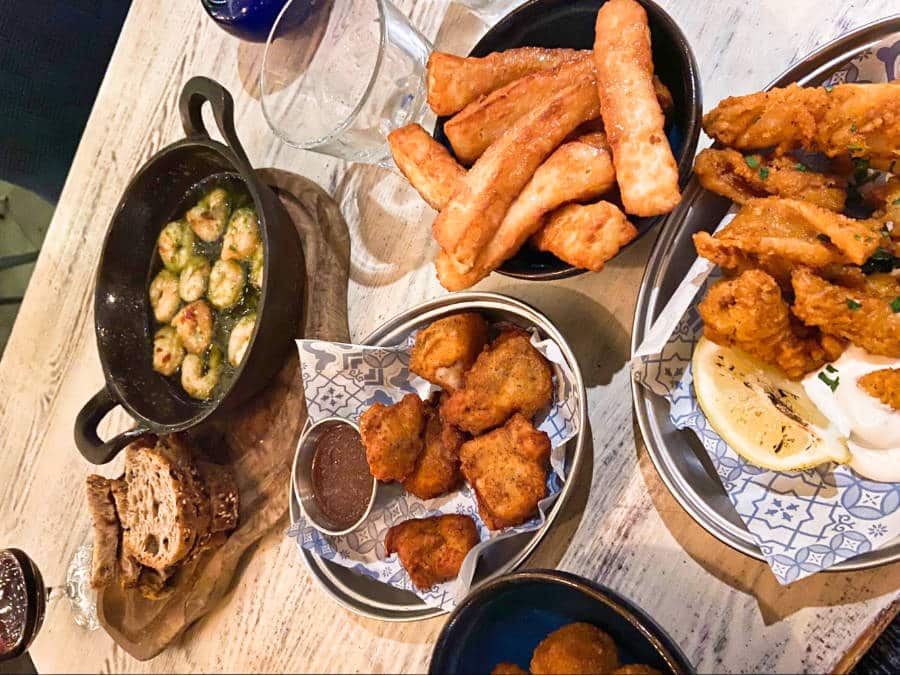View of different Mediterranean appetizers including garlic shrimp, halloumi fries, chicken bites, and calamari from Megan’s