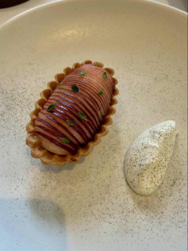 A plate with apple tart and cream