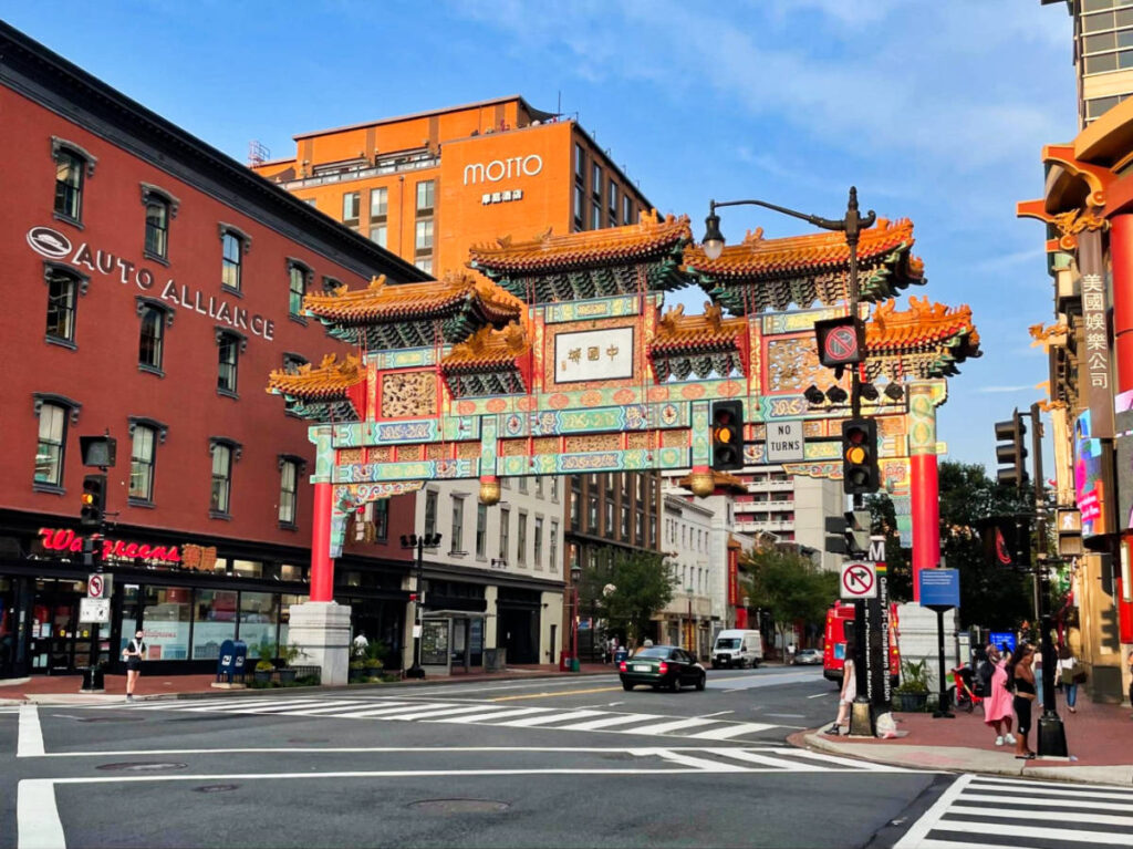 The entrance arch of Chinatown with the Motto by Hilton Hotel in the background