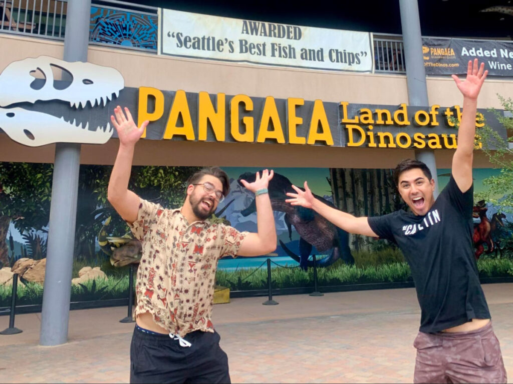 Two man posing infront of the Pangaea Land of Dinosaurs at Arizona Boardwalk