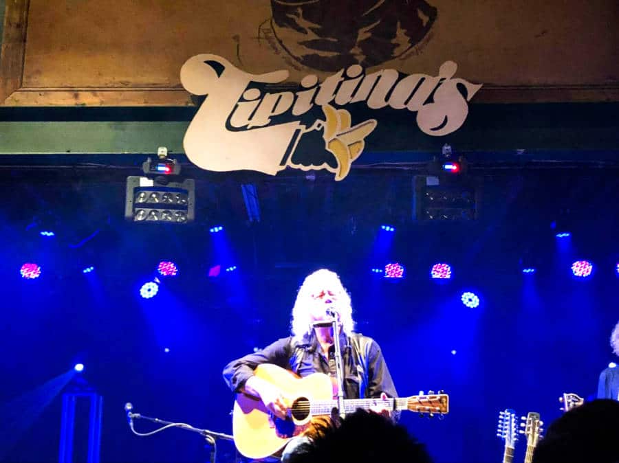 Arlo Guthrie performing on the stage of Tipitina’s music venue
