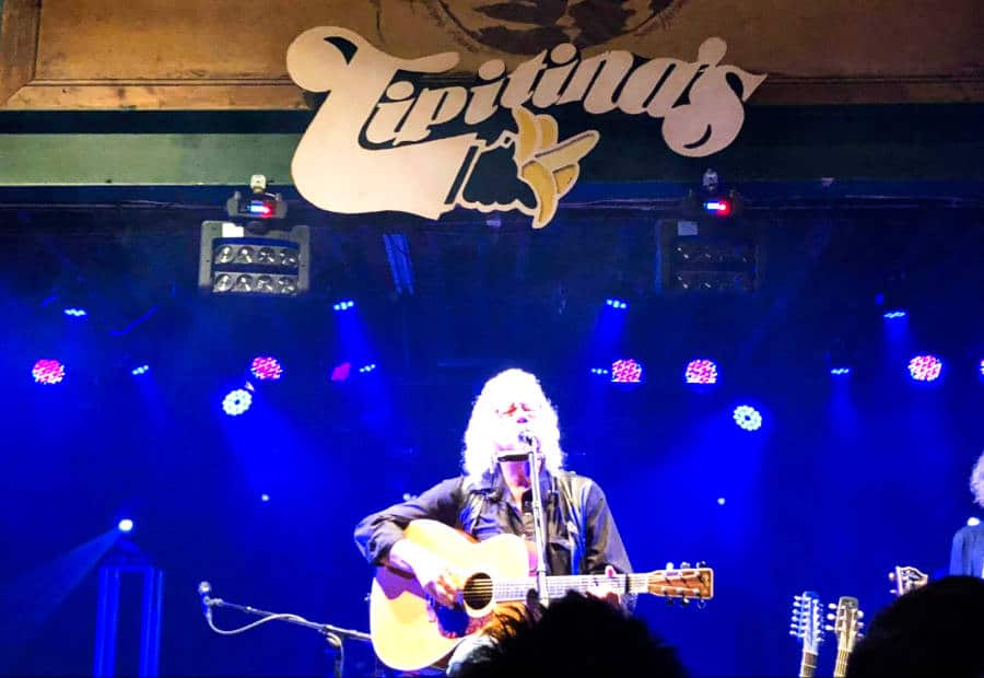 Arlo Guthrie performing on the stage of Tipitina’s music venue