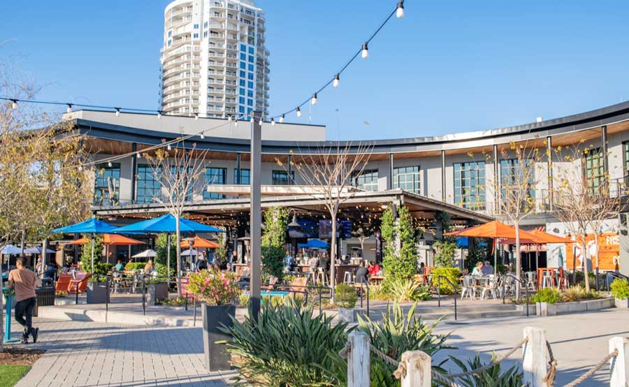 View of the communal dining hall surrounded by shops and restaurants on Tampa Riverwalk