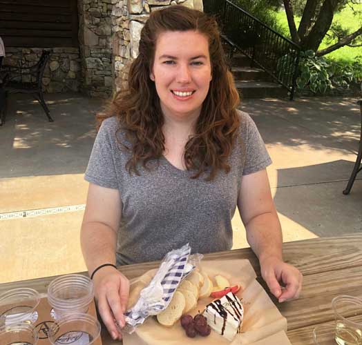 Author Elizabeth enjoying her charcuterie plate in Arrington Vineyard