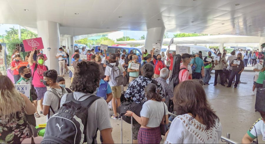 Busy crowd looking for transportation service outside Cancun Airport