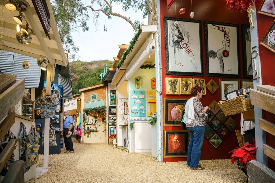 View of a lady and a man looking at the art pieces in Art Festival at the Laguna Beach