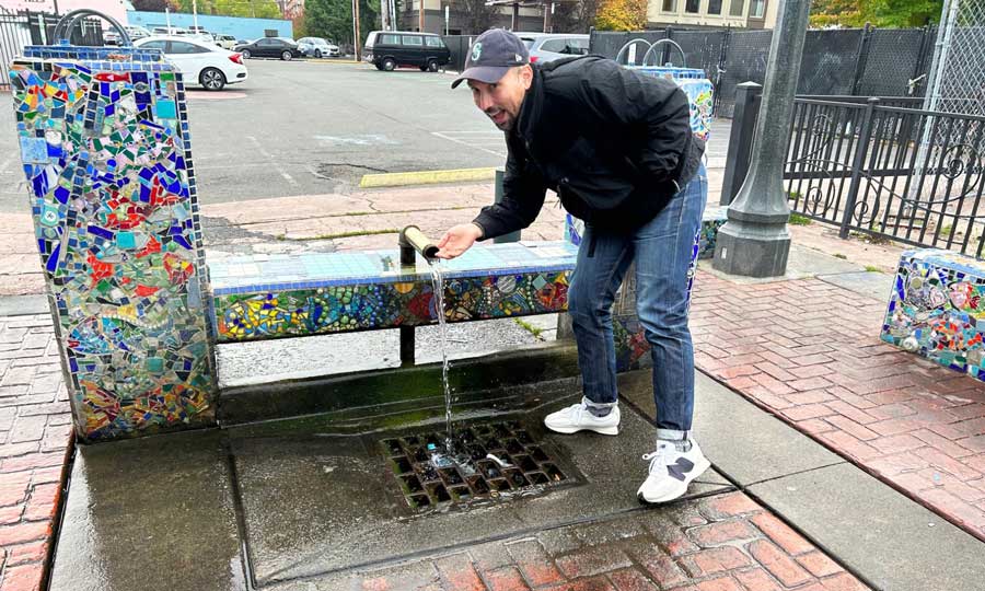 The author's husband trying out the water from Artesian Well