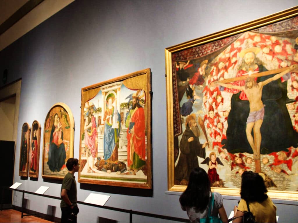 View of the people looking at the displayed artworks at the Accademia Gallery
