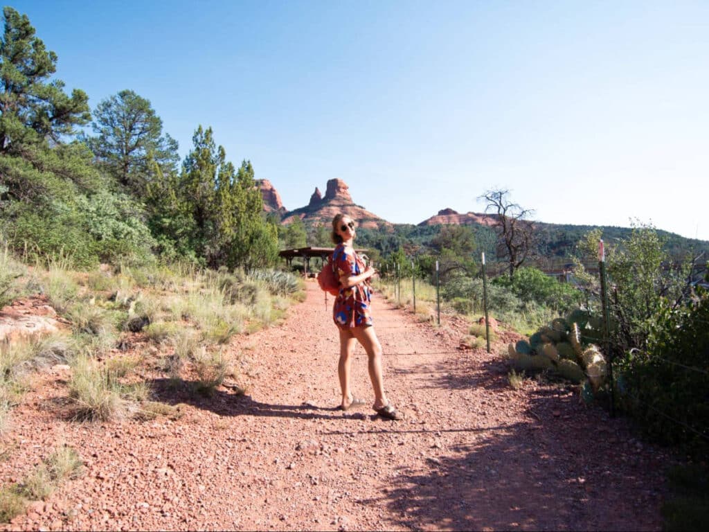 The author, Ashleigh, posing in the middle of the pathway in Cottonwood with a scenic view in the background