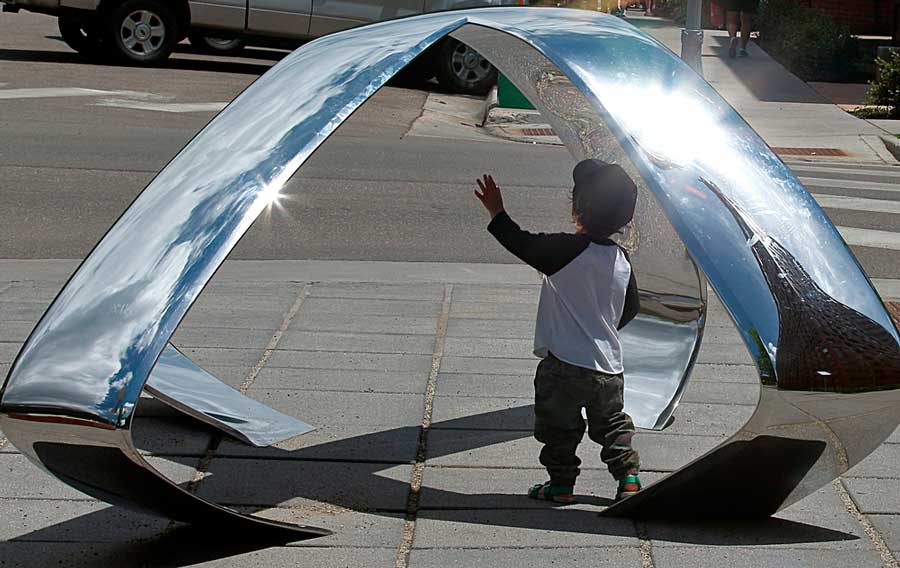 A boy playing outside the Aspen Art Museum