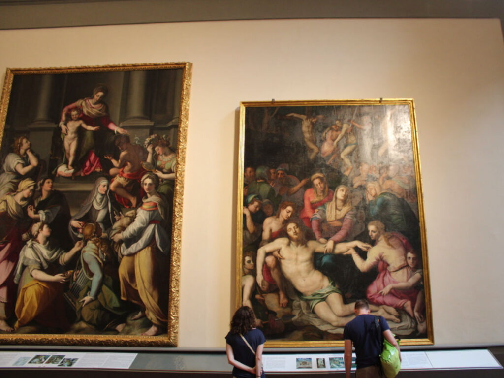 Two people looking at a painting in the Accademia Gallery