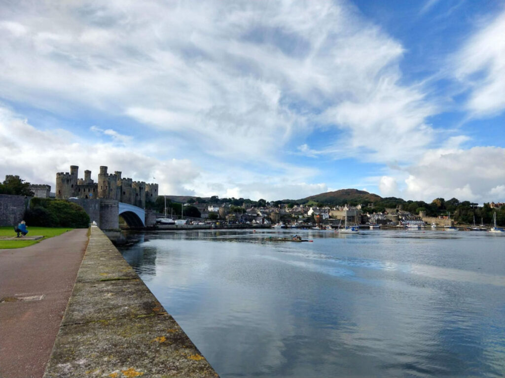 Serene body of water with the Conwy Castle towering in the background