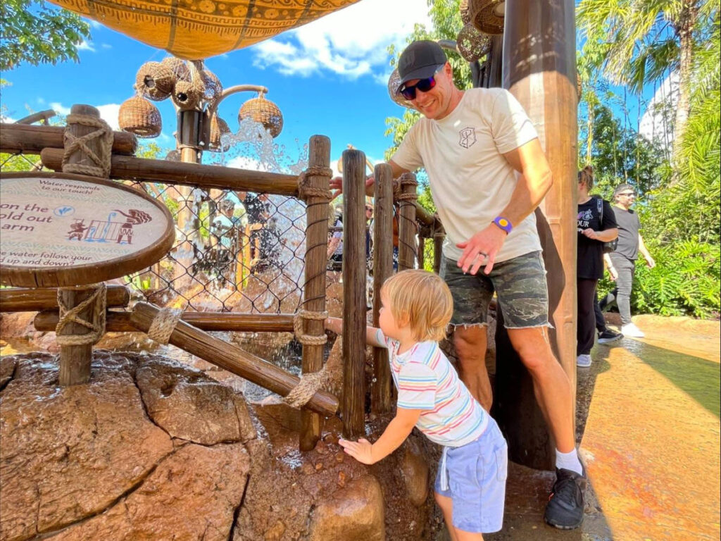 Katie's husband and son playing in the interactive water fountains