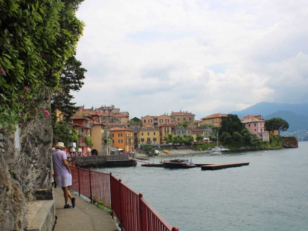 A man on the pathway looking at the view of Lake Como