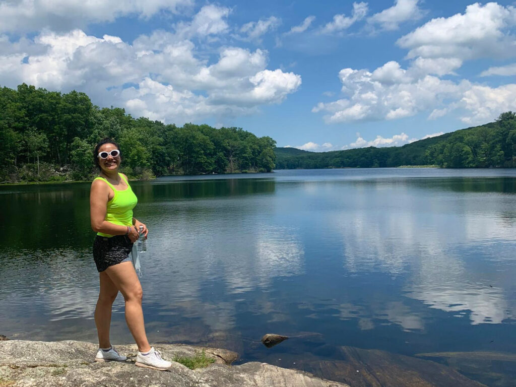 Author’s friend smiling brightly at Lake Sebago in Harriman State Park