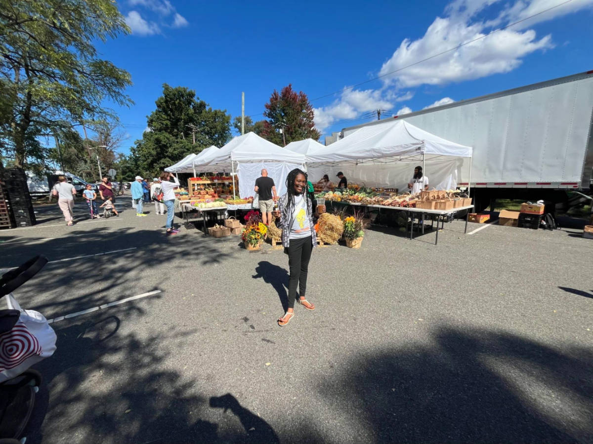 The authors daughter enjoying a drink at the Montclair Farmers Market