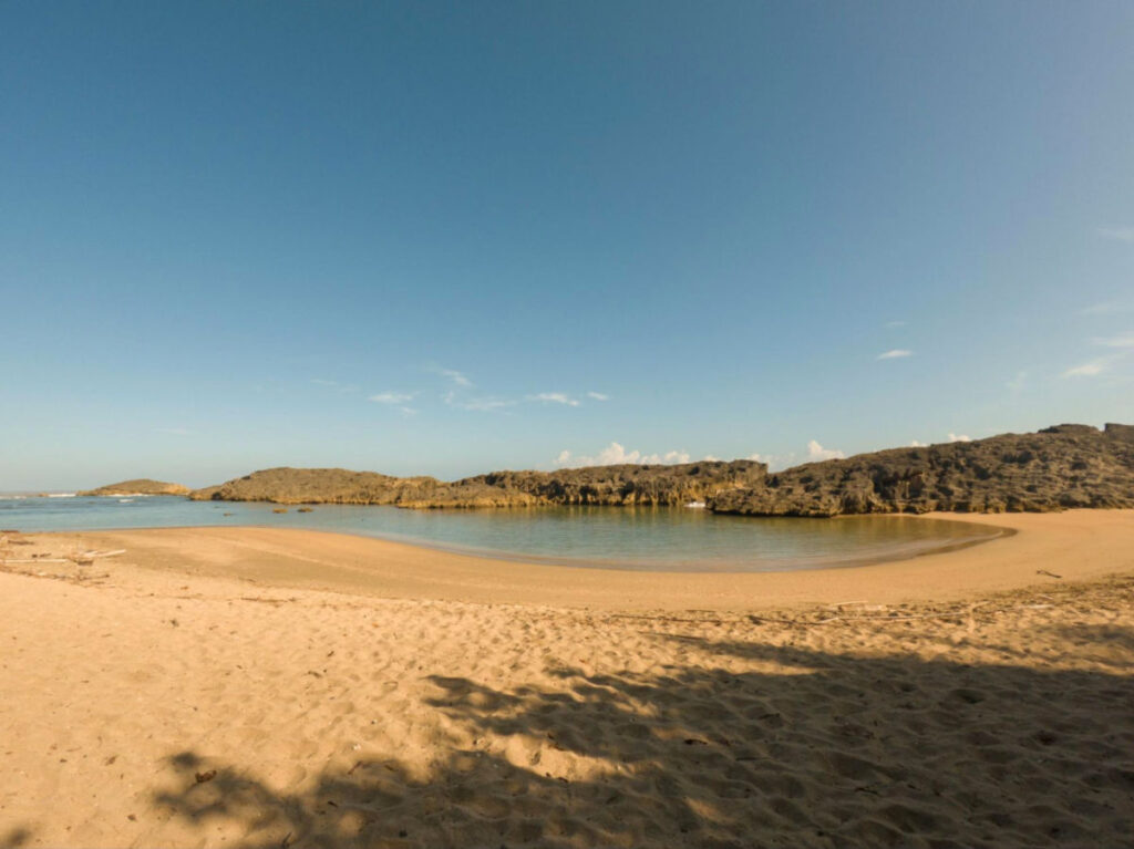View of the serene sandy beach at Playa Esperanza