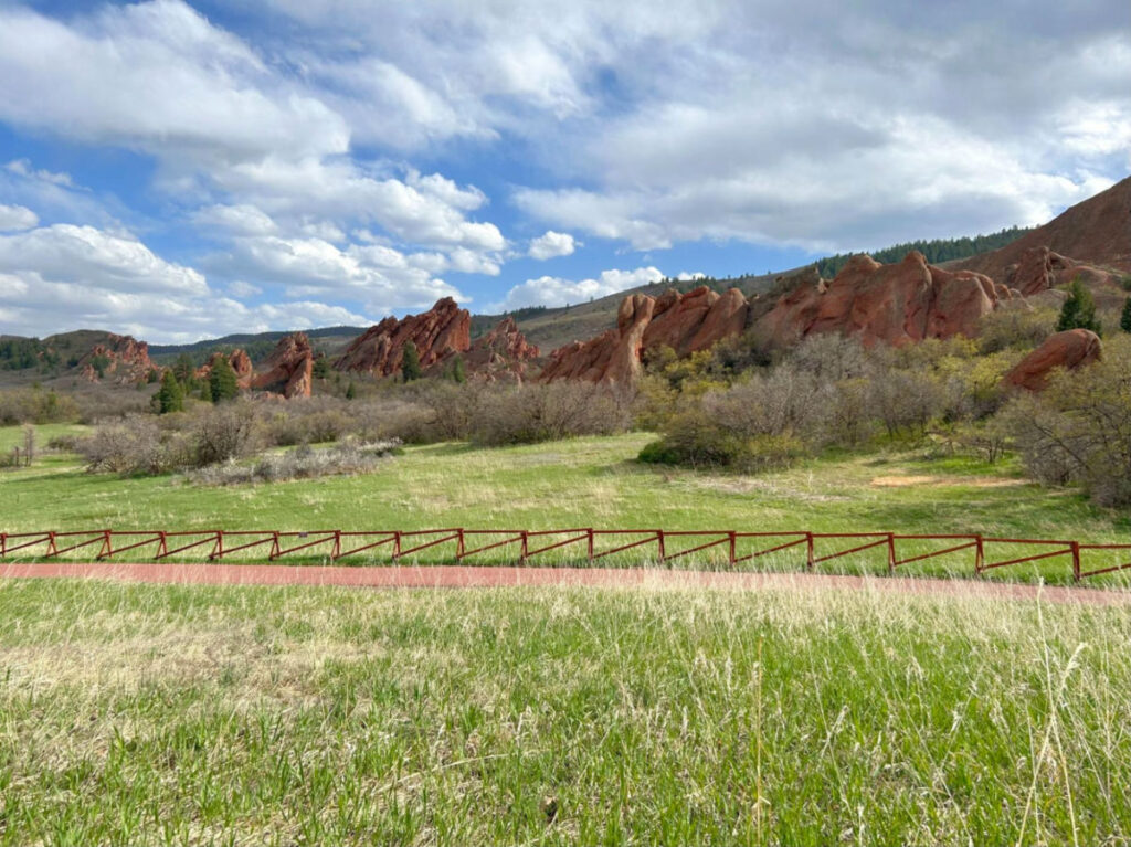 View of the Green grass and red rocks at Roxborough State Park
