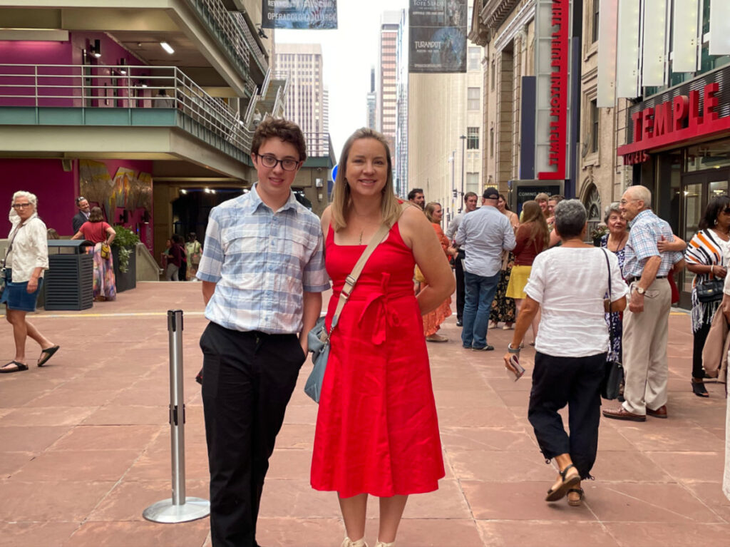 Author Laura Falin in a red dress with her friend at the Denver Center for Performing Arts
