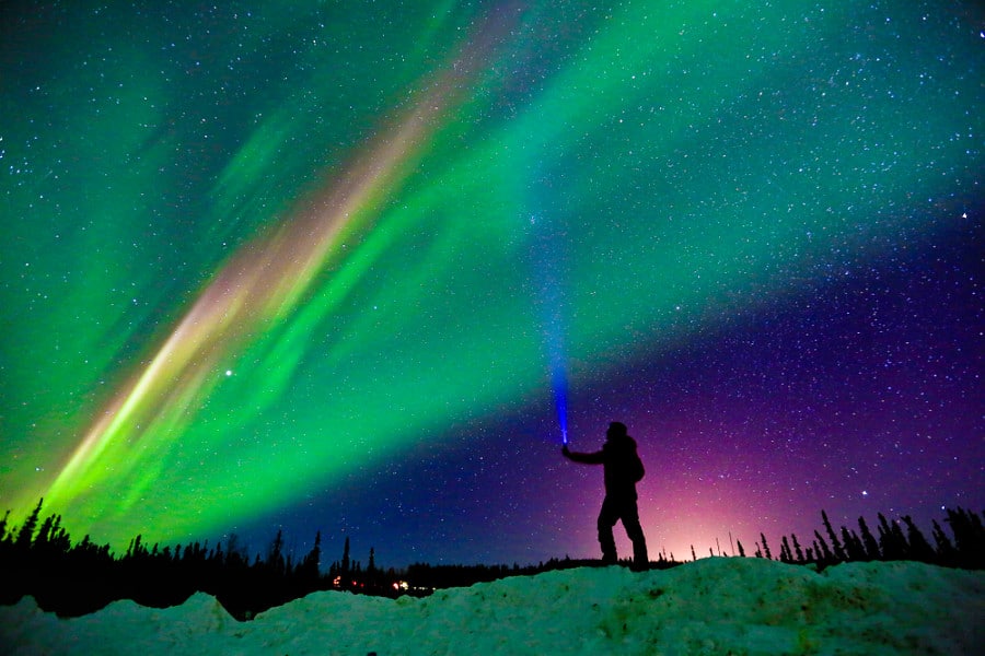 A man viewing the Aurora Northern Lights Night Sky