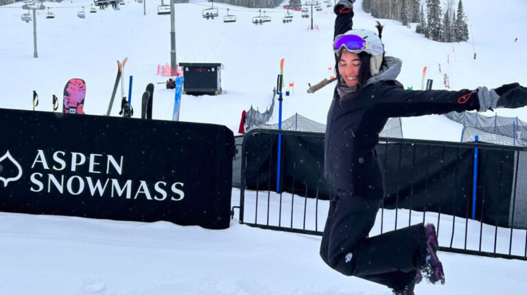 Travel Lemming editor Abigail jumping in joy at Aspen Snowmass Ski Resort
