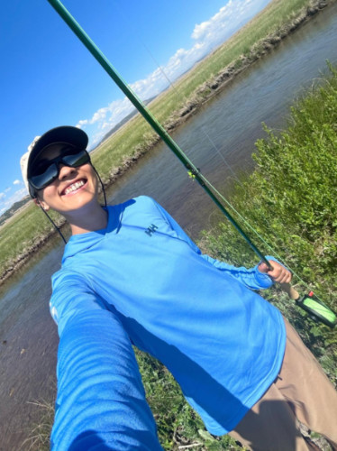 Author Abigail wearing a Moisture-wicking UPF T-Shirt while fishing