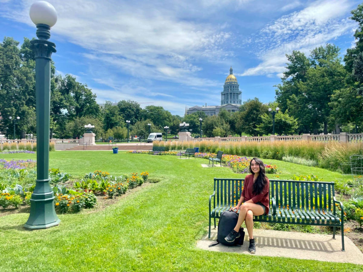 Author Abigail sitting in a bench in Civic Center Park