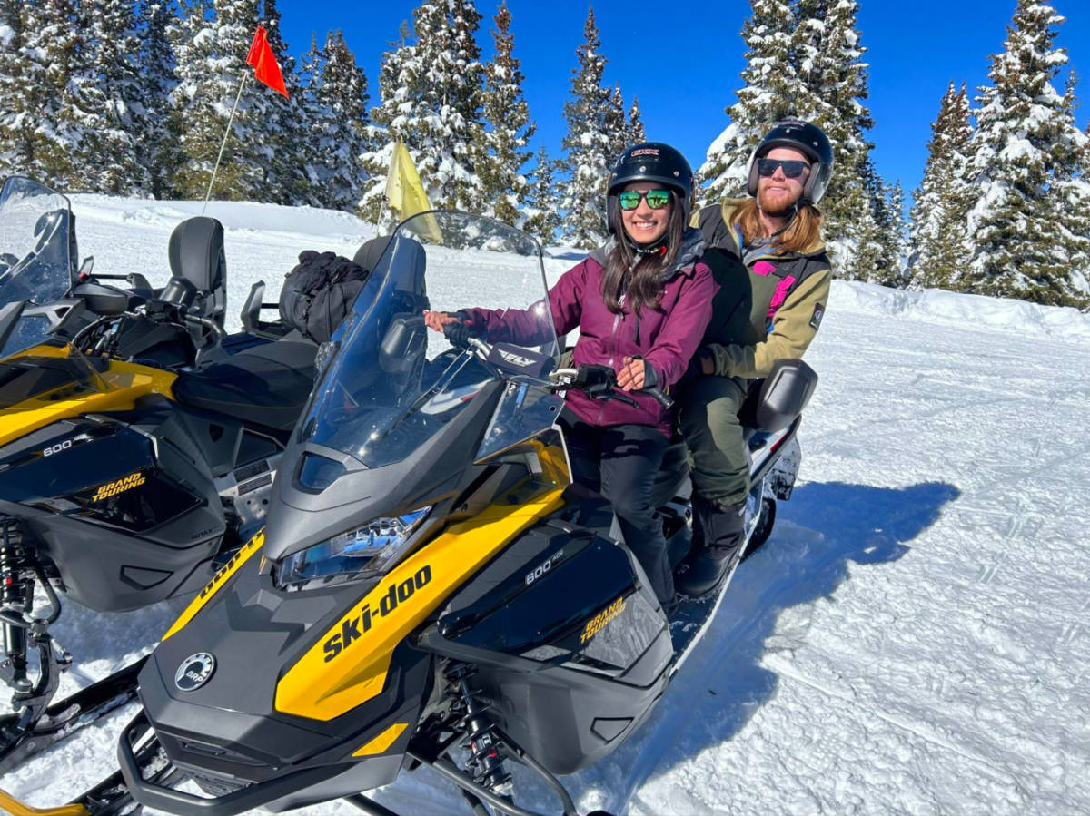 Author Abigail and her husband on a snowmobile tour