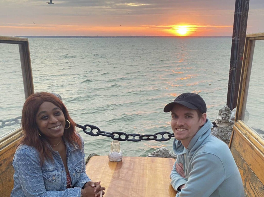 Author Alexandria and Dylan enjoying a bayside dinner in Ocean City at sunset
