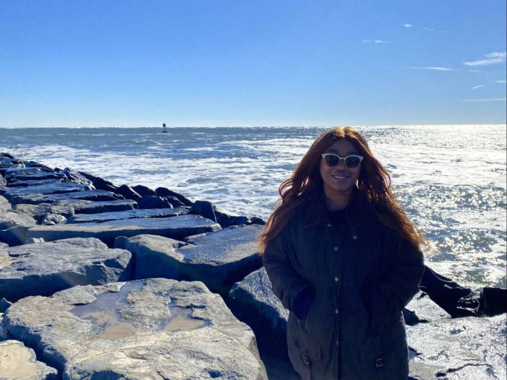 Author Alexandria standing on the rocks at the Inlet