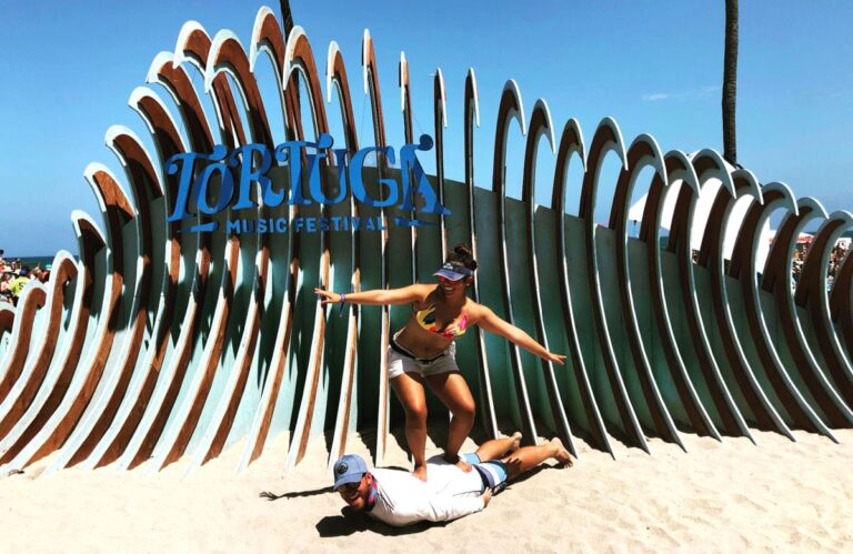 The author Andrew and her wife playfully poses for a photo in Tortuga Music Festival