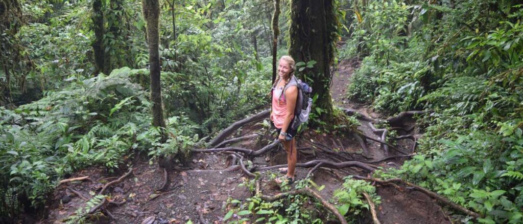 The author Ashleigh Bandimere smiling for a photo in Arenal Volcano National Park