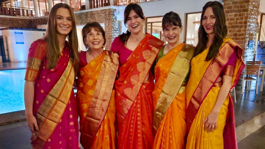 Author Betty and her family dressed in bright sarees at an Indian wedding
