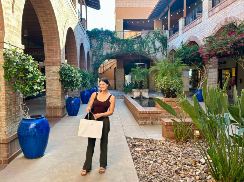 Author Betty standing at the La Encantada courtyards